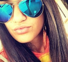 Girl with black hair and blue glasses