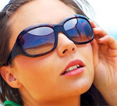 Girl with medium skin and blue/orange glasses