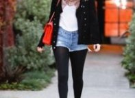 Nicole Richie wearing oversized black cat eye sunglasses