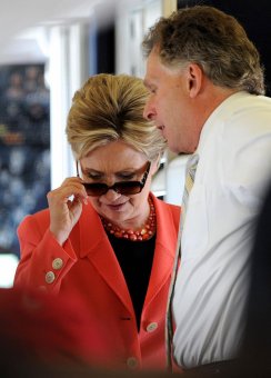 US Democratic presidential hopeful New York Senator Hillary Clinton removes her sun glasses while talking with campaign chairman Terry McAuliffe as she boards her charter plane at Dulles airport outside Washington, DC on her way to Charleston, West Virginia on May 13, 2008, the day of the state's Democratic primary election. AFP PHOTO/Robyn BECK (Photo credit should read ROBYN BECK/AFP/Getty Images)